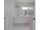 Elegant bathroom with double vanity, modern lighting, and a large mirror at 227 W 4Th St, Chuluota, FL 32766