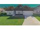 Newly built single story home with a two-car garage and manicured lawn at 227 W 4Th St, Chuluota, FL 32766