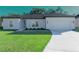 Newly constructed home with a two-car garage and well-manicured lawn at 227 W 4Th St, Chuluota, FL 32766