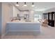Modern kitchen featuring white cabinets, quartz countertops, and an island at 227 W 4Th St, Chuluota, FL 32766