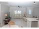 Bright living room features a neutral color palette, plush seating, and large windows at 227 W 4Th St, Chuluota, FL 32766