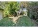Tropical backyard with lush lawn and mature trees at 230 W Spring Lake Dr, Altamonte Springs, FL 32714