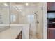 Walk-in shower with glass enclosure and beige marble tile in this updated bathroom at 230 W Spring Lake Dr, Altamonte Springs, FL 32714
