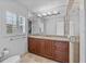 Bathroom with dark wood cabinets, granite countertop, and a large walk-in shower at 230 W Spring Lake Dr, Altamonte Springs, FL 32714