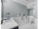 Simple bathroom with white tile, a pedestal sink and a door to outside at 230 W Spring Lake Dr, Altamonte Springs, FL 32714