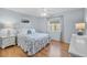 Bedroom with hardwood floors, light blue walls, and a queen-size bed at 230 W Spring Lake Dr, Altamonte Springs, FL 32714