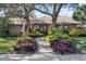 House with a walkway leading to the front door, surrounded by lush landscaping at 230 W Spring Lake Dr, Altamonte Springs, FL 32714