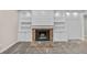 Brick fireplace with white shiplap surround and built-in shelving at 230 W Spring Lake Dr, Altamonte Springs, FL 32714