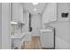 Bright laundry room with white cabinets and built-in storage at 230 W Spring Lake Dr, Altamonte Springs, FL 32714