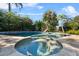 Relaxing pool and spa with tiled deck and lush landscaping at 230 W Spring Lake Dr, Altamonte Springs, FL 32714
