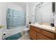 Clean bathroom with a shower/tub combo and wood vanity at 2394 Caravelle Cir, Kissimmee, FL 34746