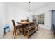 Dining area with wooden table, bench seating, and natural light at 2394 Caravelle Cir, Kissimmee, FL 34746