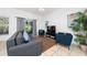 Comfortable living room with gray sofa and blue armchairs at 2394 Caravelle Cir, Kissimmee, FL 34746