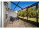 Screened patio with table and chairs, overlooking backyard at 2394 Caravelle Cir, Kissimmee, FL 34746