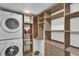 Convenient laundry room with washer, dryer, and shelving at 3203 Westridge Blvd # 102, Orlando, FL 32822