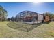 Large backyard with a screened pool and patio area at 334 Orange Cosmos Blvd, Davenport, FL 33837