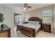 Main bedroom with king-size bed and access to a patio at 334 Orange Cosmos Blvd, Davenport, FL 33837