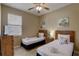 Twin bedroom with wood furniture and ceiling fan at 334 Orange Cosmos Blvd, Davenport, FL 33837