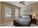 Bedroom with queen bed, ceiling fan, and large windows at 334 Orange Cosmos Blvd, Davenport, FL 33837