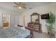 Main bedroom with king bed, dresser, and bathroom access at 334 Orange Cosmos Blvd, Davenport, FL 33837