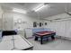 Game room with pool table, air hockey, and laundry area at 334 Orange Cosmos Blvd, Davenport, FL 33837