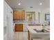 Well-equipped kitchen with wood cabinets and white appliances at 334 Orange Cosmos Blvd, Davenport, FL 33837