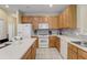 Bright kitchen with wood cabinets, island, and stainless steel appliances at 334 Orange Cosmos Blvd, Davenport, FL 33837