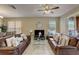 Comfortable living room featuring two brown leather couches and a large TV at 334 Orange Cosmos Blvd, Davenport, FL 33837