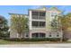 Two-story building with screened balconies and lush landscaping at 3406 Soho St # B6, Orlando, FL 32835