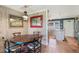 Charming dining area with rustic wood table and colorful chairs at 3663 S Atlantic Ave # 11D, New Smyrna Beach, FL 32169