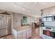 Open kitchen with island, stainless appliances, and living area view at 3663 S Atlantic Ave # 11D, New Smyrna Beach, FL 32169