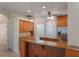 Island kitchen with granite countertops and wood cabinets at 389 Mohave Terrace, Lake Mary, FL 32746