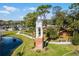 Aerial view of a town square with a clock tower and pond at 389 Mohave Terrace, Lake Mary, FL 32746