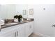 Bathroom with double vanity, white cabinets, and gray countertop at 4355 Scene Ln, Kissimmee, FL 34746
