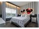 Bright bedroom with a king-size bed, window, and themed decor at 4355 Scene Ln, Kissimmee, FL 34746