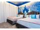 Two twin beds in a themed bedroom with a castle wall and blue accents at 4355 Scene Ln, Kissimmee, FL 34746