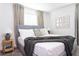 Bedroom with a king-size bed and gray knit throw blanket at 4355 Scene Ln, Kissimmee, FL 34746