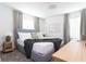 Spacious bedroom with gray platform bed and large windows at 4355 Scene Ln, Kissimmee, FL 34746