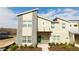 Modern townhome with green door and stone accents at 4355 Scene Ln, Kissimmee, FL 34746