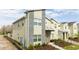 Modern two-story townhome with stone accents and landscaped walkway at 4355 Scene Ln, Kissimmee, FL 34746