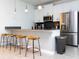 Modern kitchen with white cabinets, stainless steel appliances, and breakfast bar at 4355 Scene Ln, Kissimmee, FL 34746