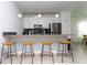 Modern kitchen with white cabinets, stainless steel appliances, and an island with seating at 4355 Scene Ln, Kissimmee, FL 34746