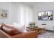 Living room with brown leather couch and large TV at 4355 Scene Ln, Kissimmee, FL 34746