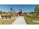 Community playground with wooden benches nearby at 4355 Scene Ln, Kissimmee, FL 34746