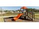 Community playground with two orange slides at 4355 Scene Ln, Kissimmee, FL 34746