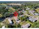 Beautiful aerial view of a single-story home in a lush, green neighborhood with mature trees at 5526 Lily Rd, Lakeland, FL 33811