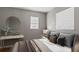 Bedroom features a grey bed, warm lighting, and a minimalist design at 5526 Lily Rd, Lakeland, FL 33811