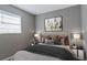 Bedroom features a grey bed, warm lighting, and a large picture above the bed at 5526 Lily Rd, Lakeland, FL 33811