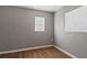 Bedroom with wood-look floors and two windows at 5526 Lily Rd, Lakeland, FL 33811