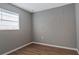 Empty bedroom featuring wood-look floors and a window at 5526 Lily Rd, Lakeland, FL 33811